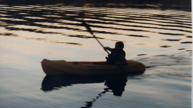 Silhouette of author's child when young, learning to kayak.