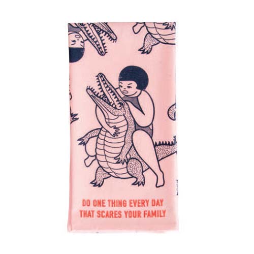 Dishtowel with a drawing of a girl wrestling an alligator, with the words