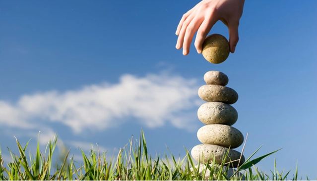 hand stacking stones