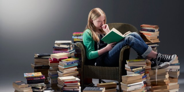 reading girl surrounded by books