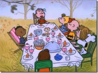 The Peanuts gang sitting at a dinner table.
