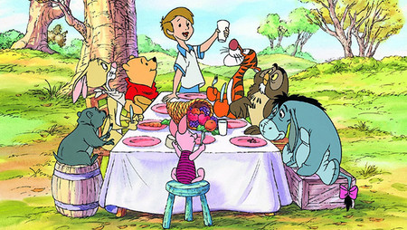 Winne-the-pooh gang all seated at a table.