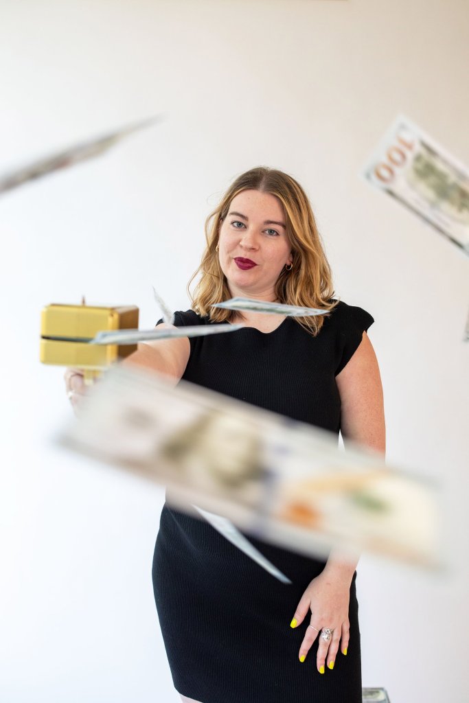 Tori Dunlap with a handheld money-raining machine